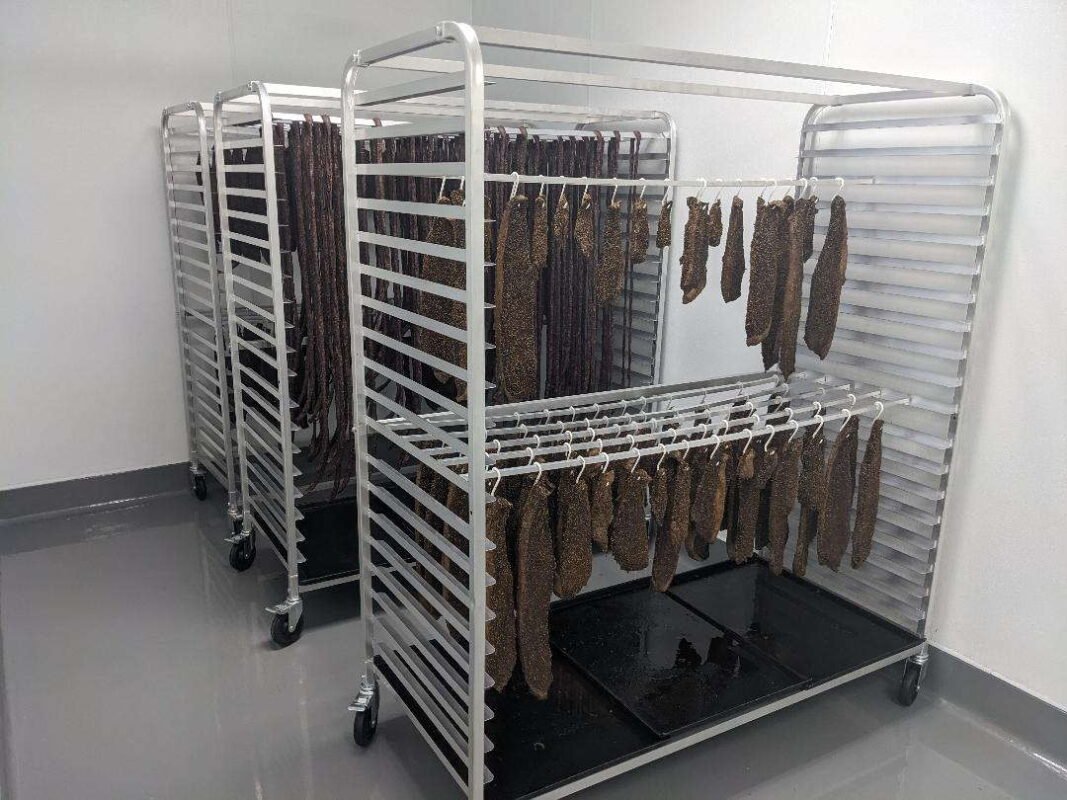 Biltong hanging in a curing chamber